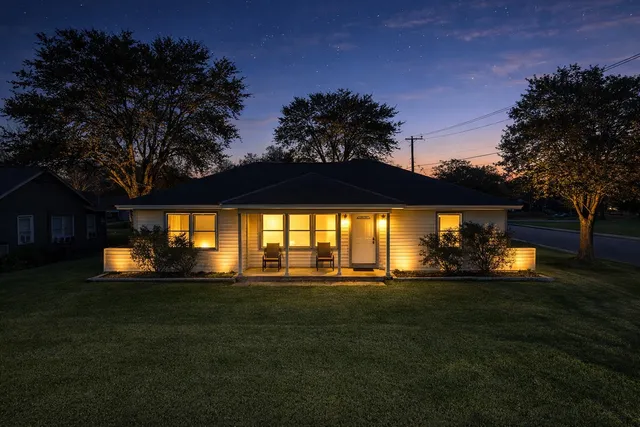 a front view of a house with a big yard