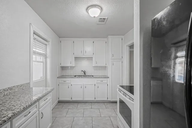 a kitchen with a sink and cabinets