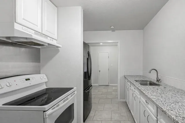 a view of a room with furniture and wooden floor