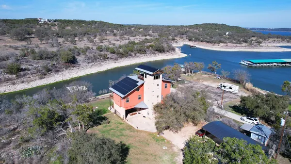 an aerial view of a house with a lake view