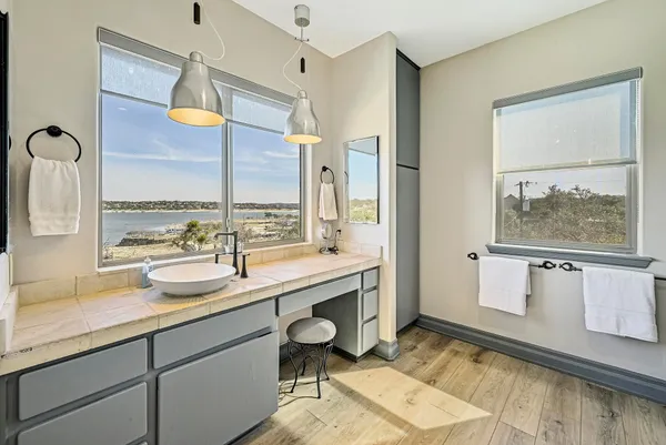 a spacious bathroom with a granite countertop sink mirror and a shower