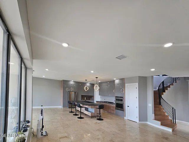 a bedroom with a bed and a refrigerator