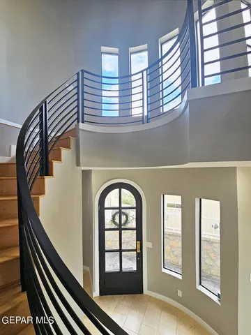 a bedroom with a bed and a ceiling fan