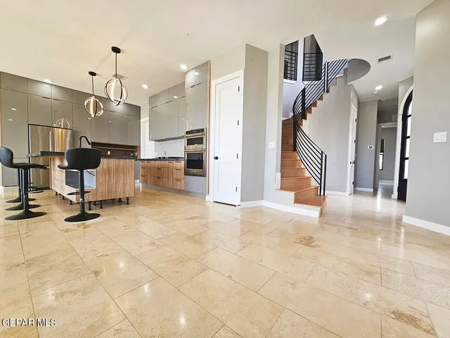 a view of a kitchen with a sink and a dishwasher with wooden floor