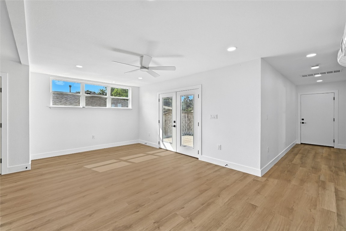 815 Buckingham Place Austin, TX 78745 - Photo 13 of 33 an empty room with wooden floor and windows