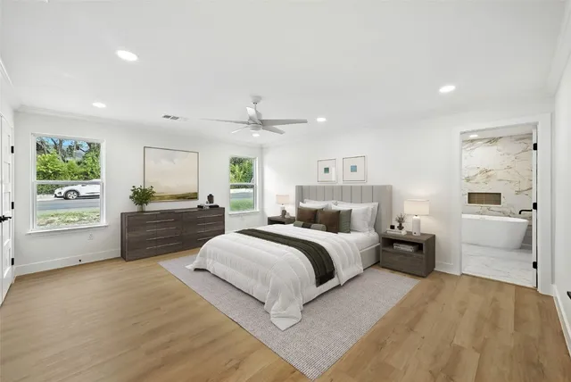 a large bedroom with a bed and a large window