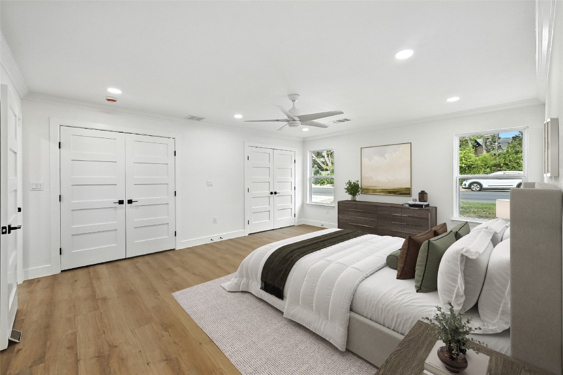 815 Buckingham Place Austin, TX 78745 - Photo 15 of 33 a spacious bedroom with a bed and a chandelier