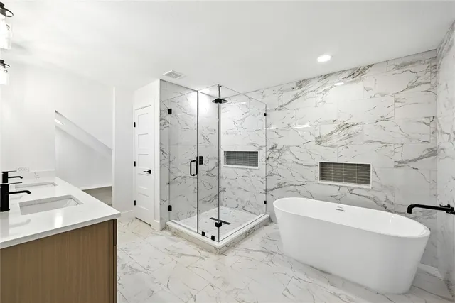 a bathroom with a bathtub and a shower