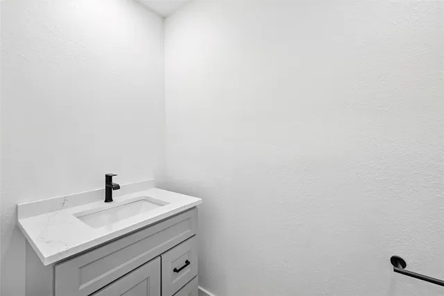 a bathroom with a sink and mirror