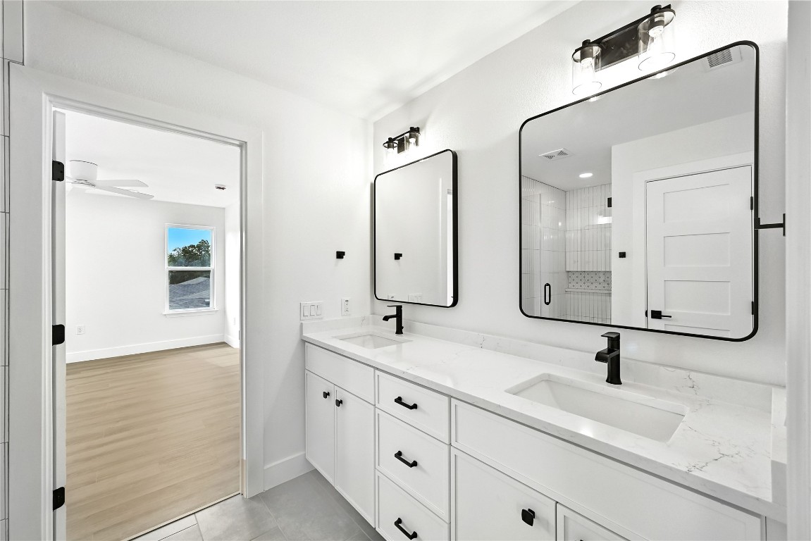 815 Buckingham Place Austin, TX 78745 - Photo 24 of 33 a bathroom with double sink and a mirror