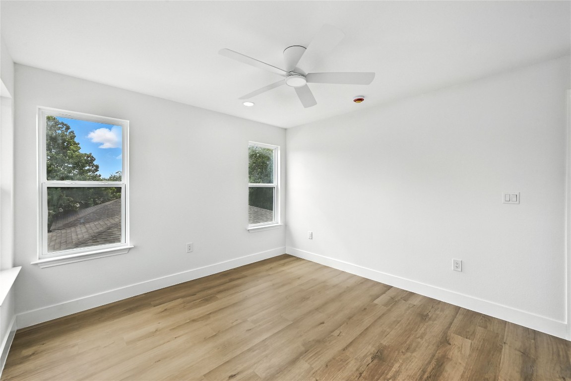 815 Buckingham Place Austin, TX 78745 - Photo 27 of 33 a view of an empty room with a window and wooden floor