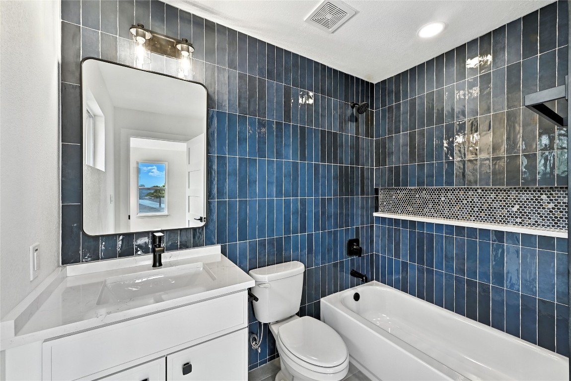 815 Buckingham Place Austin, TX 78745 - Photo 29 of 33 a bathroom with a toilet a sink and mirror