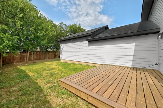 a view of a house with pool and a yard