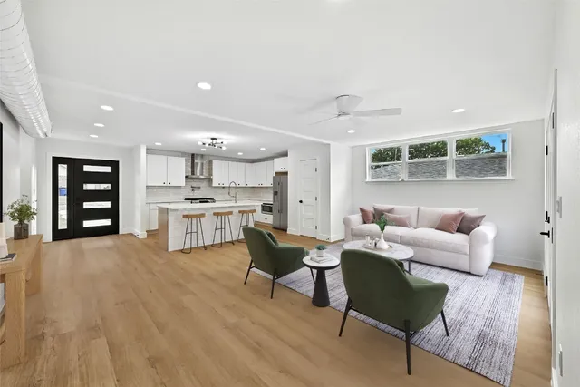 a living room with furniture and kitchen view