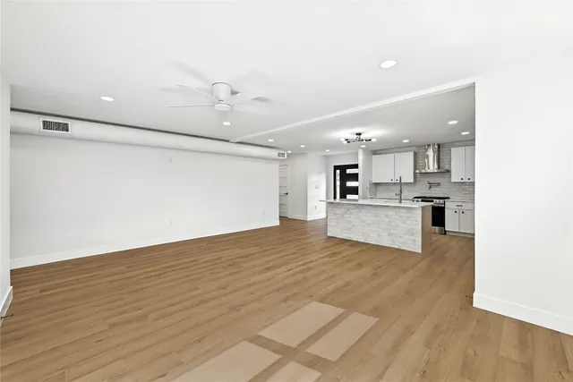 a view of a kitchen with a sink and cabinets