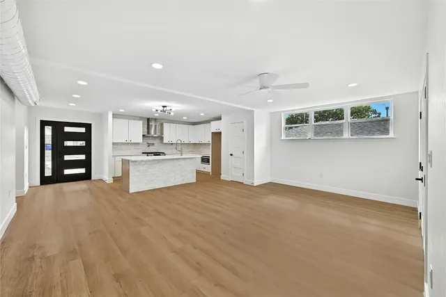 a view of an empty room with a kitchen