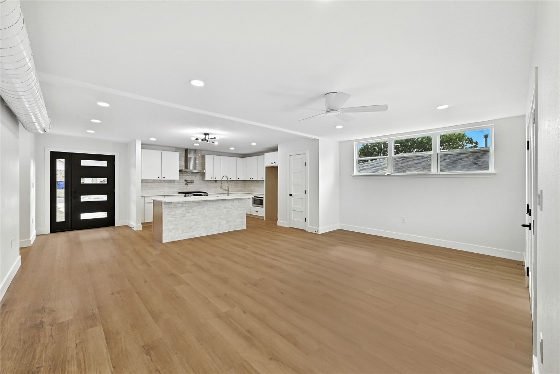 815 Buckingham Place Austin, TX 78745 - Photo 6 of 33 a view of an empty room with a kitchen