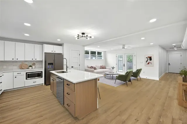 a kitchen with a sink appliances and cabinets
