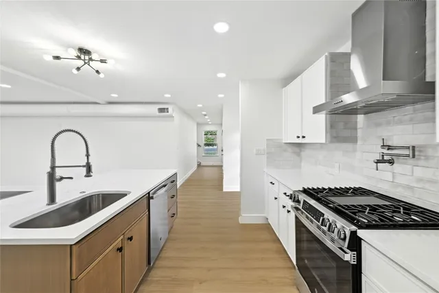 a kitchen with granite countertop a sink and stove
