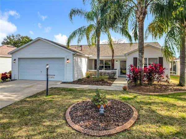 a view of a house with swimming pool and a yard