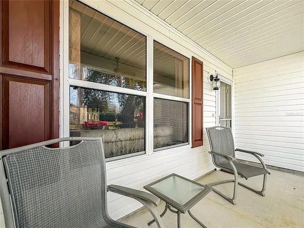 a balcony with table and chairs