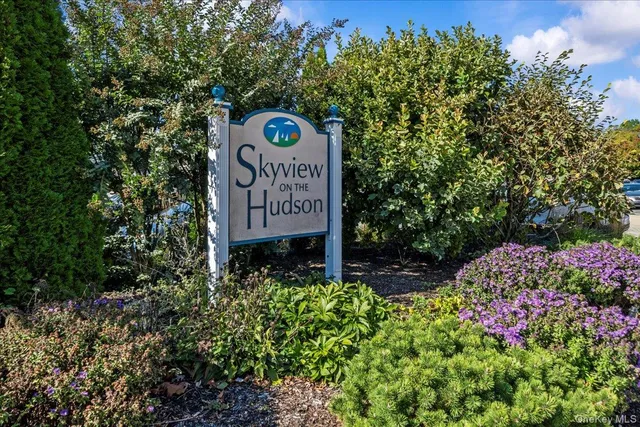 a sign that is sitting in front of flowers