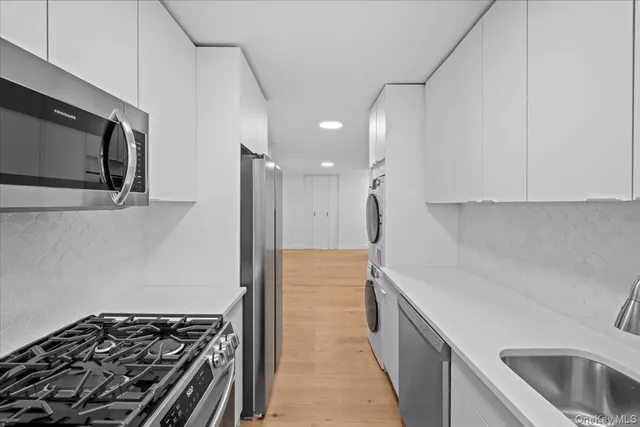 a kitchen with a sink and a stove top oven
