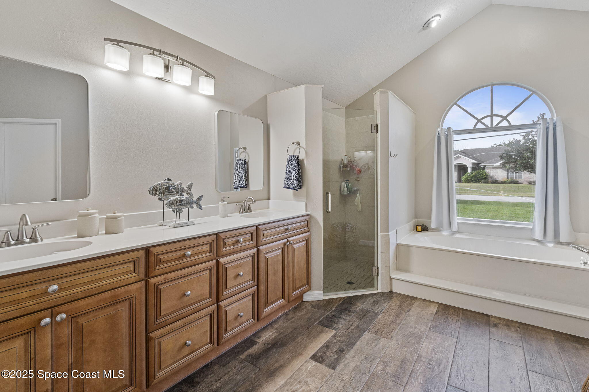 4089 Mallard Drive Melbourne, FL 32934 - Photo 15 of 53 a spacious bathroom with a double vanity sink a large mirror and a shower