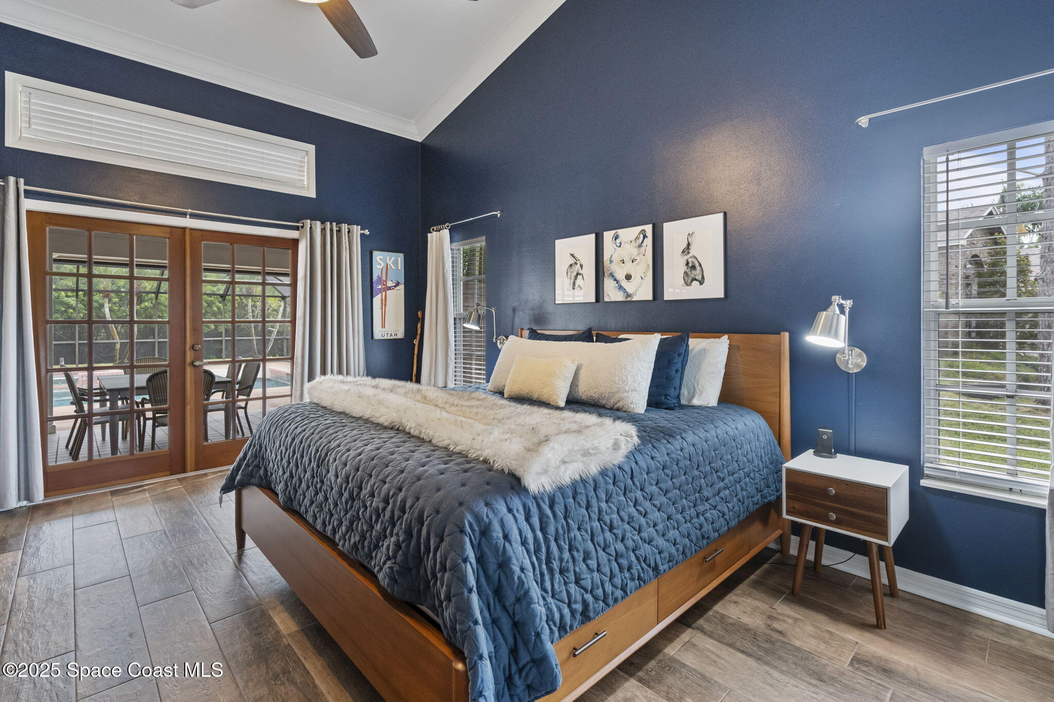 4089 Mallard Drive Melbourne, FL 32934 - Photo 18 of 53 a bedroom with a bed and wooden floor