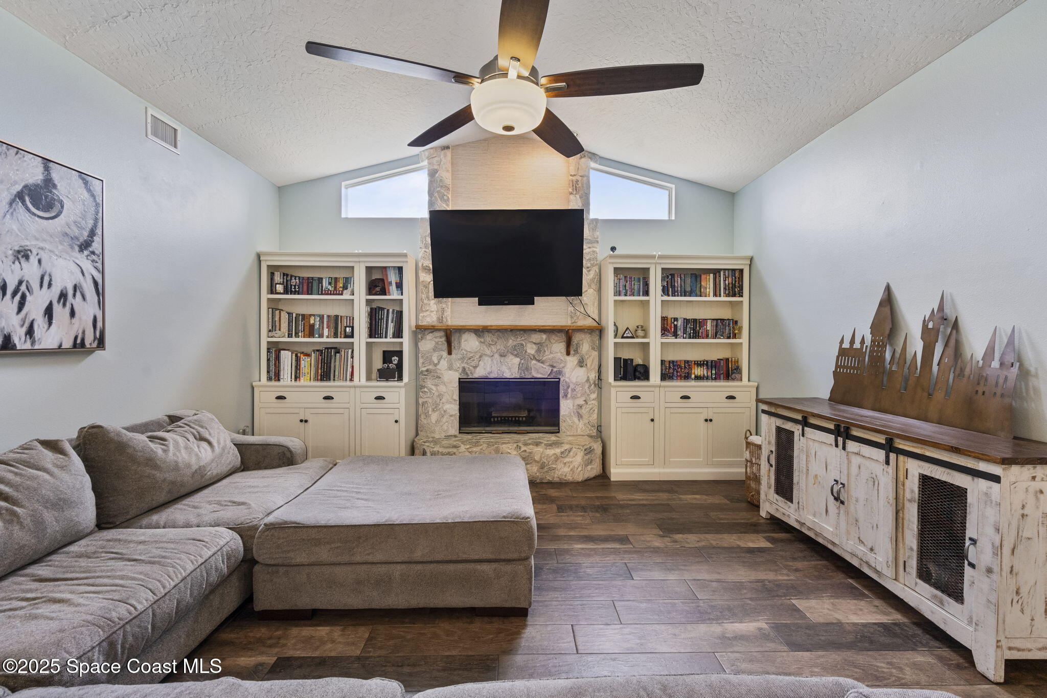 4089 Mallard Drive Melbourne, FL 32934 - Photo 25 of 53 a living room with furniture fireplace and flat screen tv