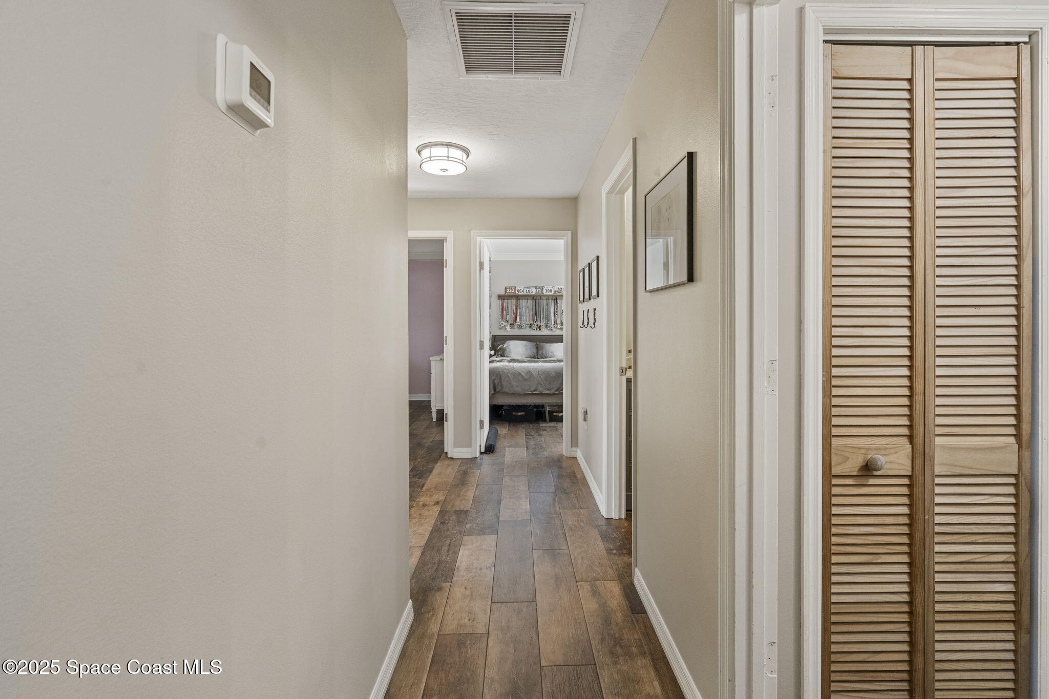 4089 Mallard Drive Melbourne, FL 32934 - Photo 28 of 53 a view of a hallway with wooden floor and closet area