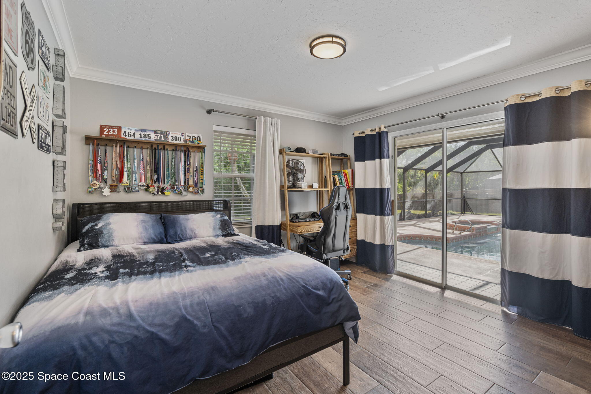 4089 Mallard Drive Melbourne, FL 32934 - Photo 32 of 53 a bedroom with a large bed and a walk in closet