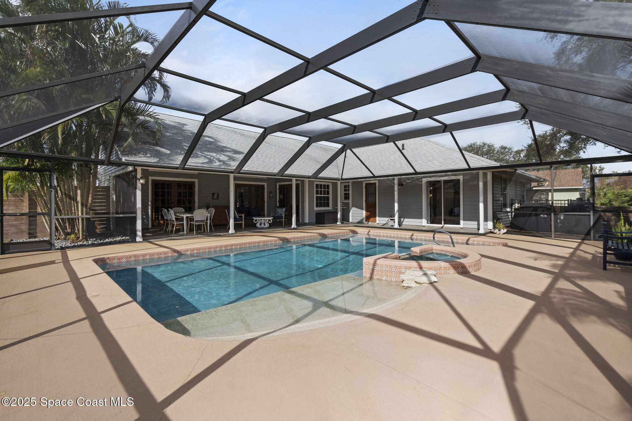 4089 Mallard Drive Melbourne, FL 32934 - Photo 37 of 53 a view of a patio with a table and chairs under an umbrella