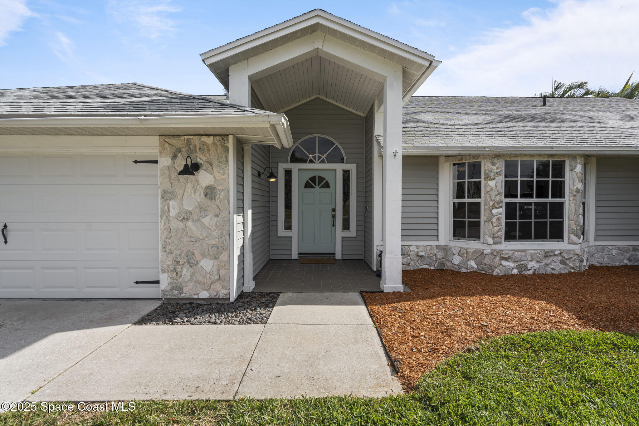4089 Mallard Drive Melbourne, FL 32934 - Photo 4 of 53 a front view of a house with a yard