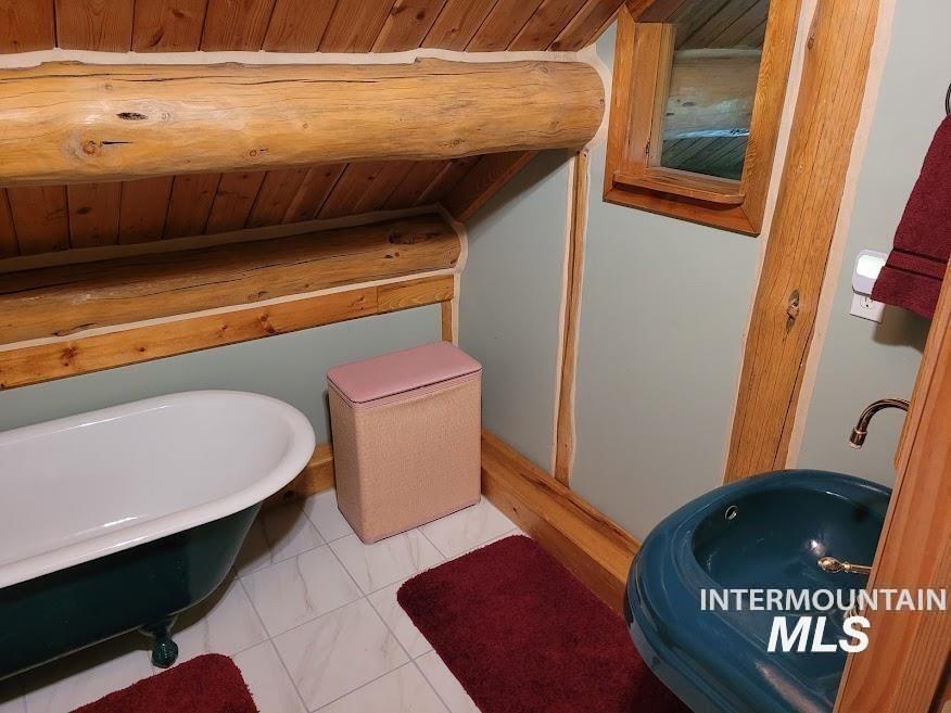 112 Three Forks Road Kamiah, ID 83536 - Photo 24 of 45 Bathroom with a freestanding tub, wood ceiling, and light tile patterned floors