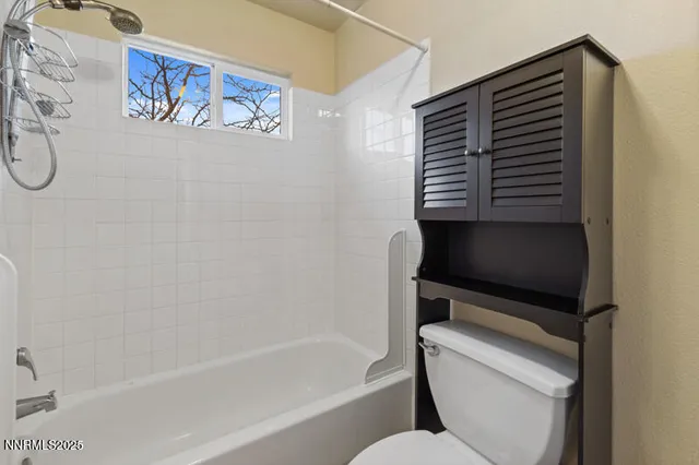 a bathroom with a toilet and a bathtub