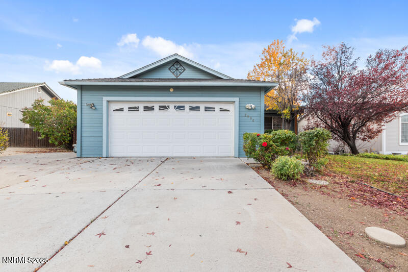 2990 Scottsdale Road Reno, NV 89512 - Photo 2 of 18 a front view of a house with a yard and garage