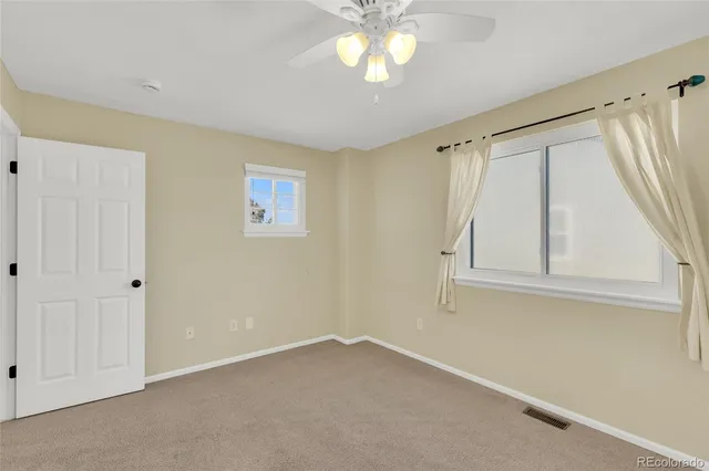 an empty room with windows and closet