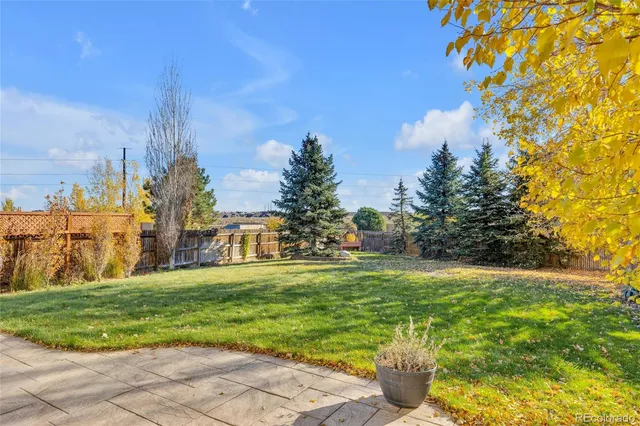 a view of a garden with a building in the background