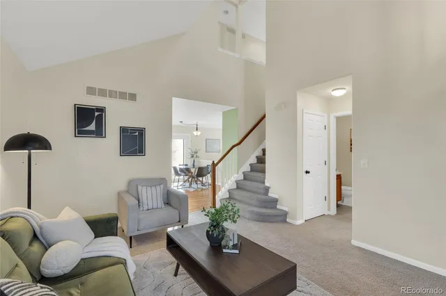 a living room with furniture and a potted plant