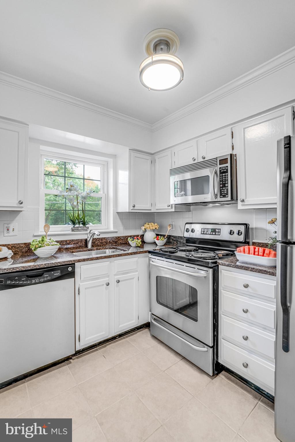 2106 North Scott Street, Unit 40 Arlington, VA 22209 - Photo 13 of 34 a kitchen with stainless steel appliances granite countertop a stove and a sink