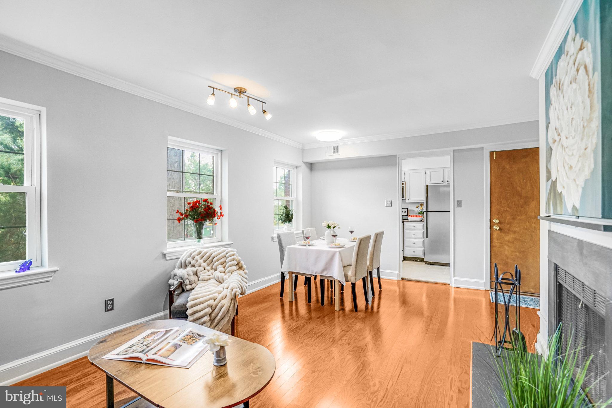 2106 North Scott Street, Unit 40 Arlington, VA 22209 - Photo 16 of 34 a dining room with furniture a window and wooden floor