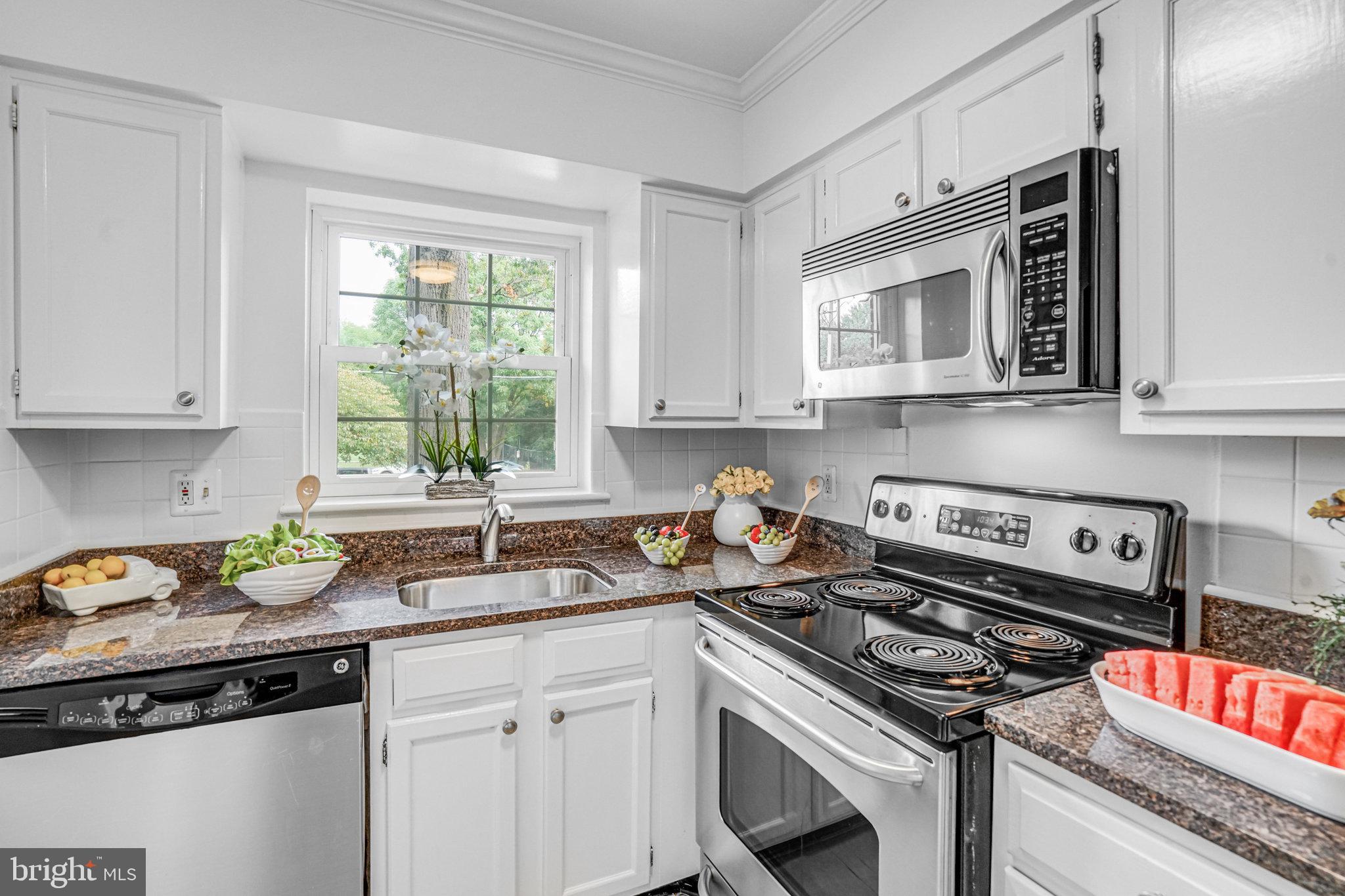 2106 North Scott Street, Unit 40 Arlington, VA 22209 - Photo 17 of 34 a kitchen with stainless steel appliances granite countertop a sink stove and cabinets