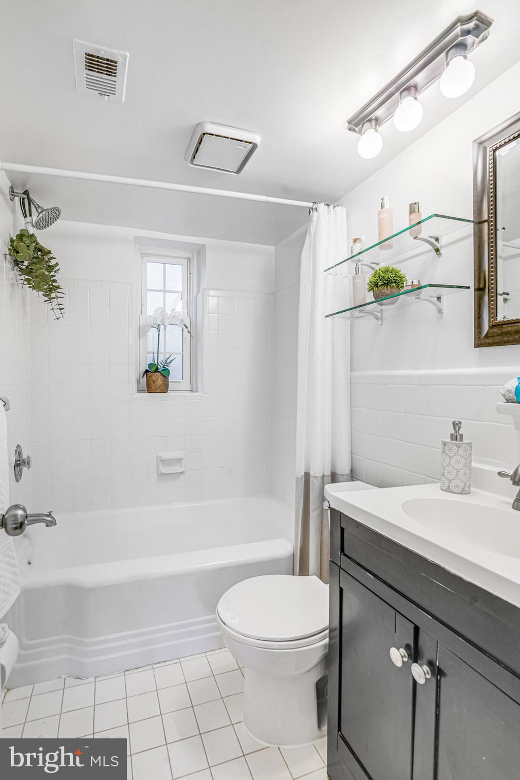 2106 North Scott Street, Unit 40 Arlington, VA 22209 - Photo 24 of 34 a bathroom with a sink a toilet and shower