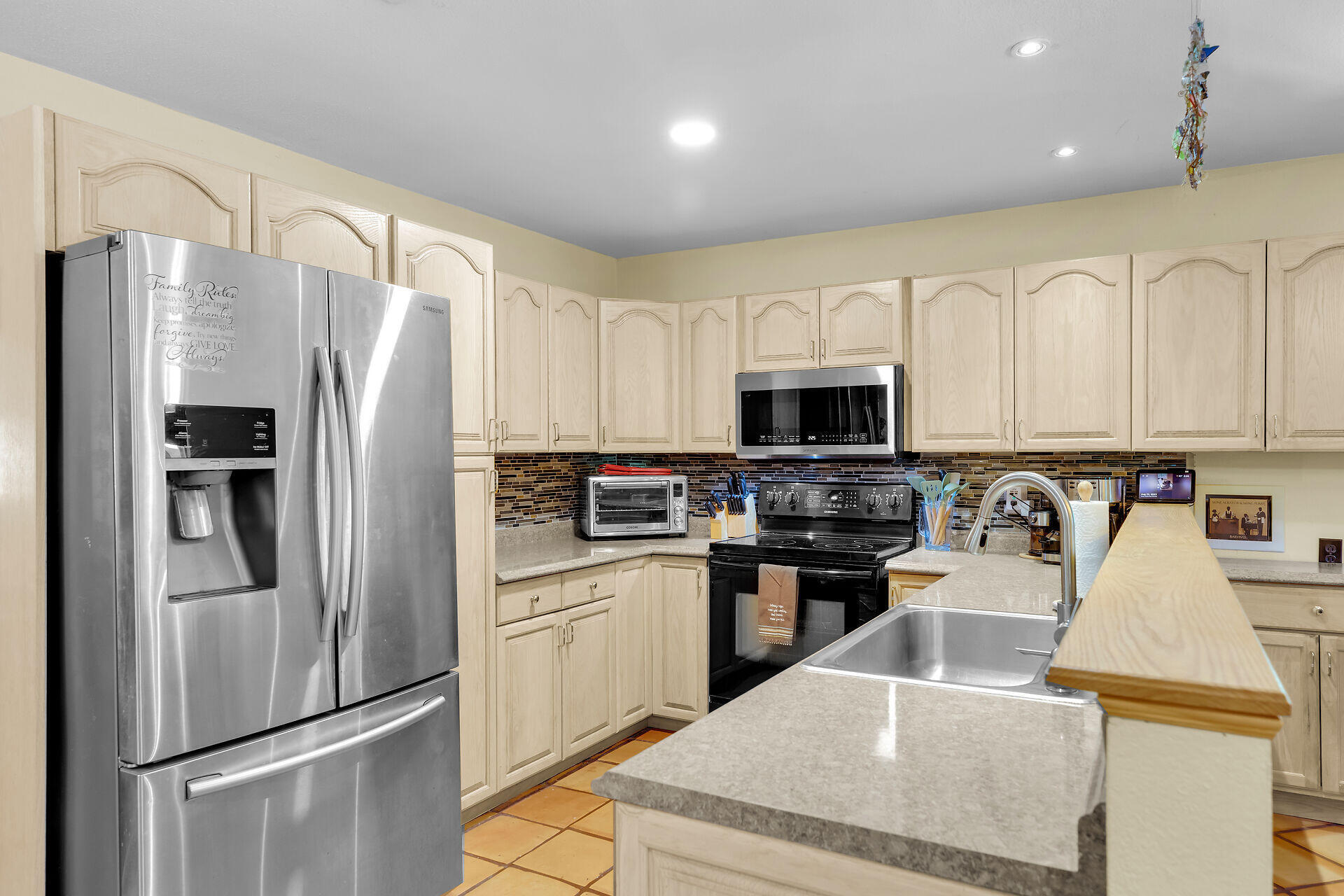 323 Bayview Avenue Key Largo, FL 33037 - Photo 23 of 46 a kitchen with stainless steel appliances granite countertop a refrigerator a stove top oven a sink and dishwasher