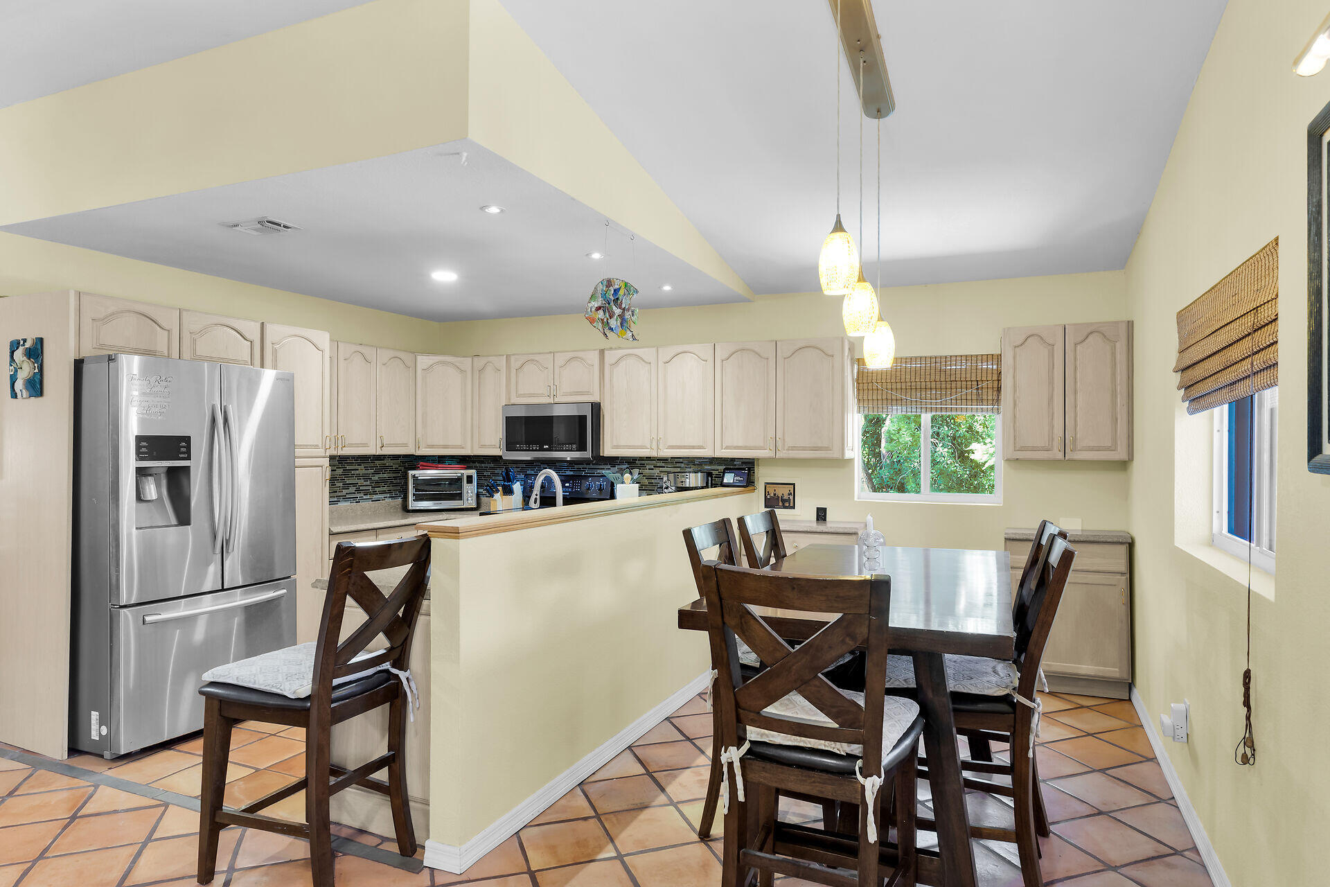 323 Bayview Avenue Key Largo, FL 33037 - Photo 25 of 46 a kitchen with stainless steel appliances a dining table chairs refrigerator and sink