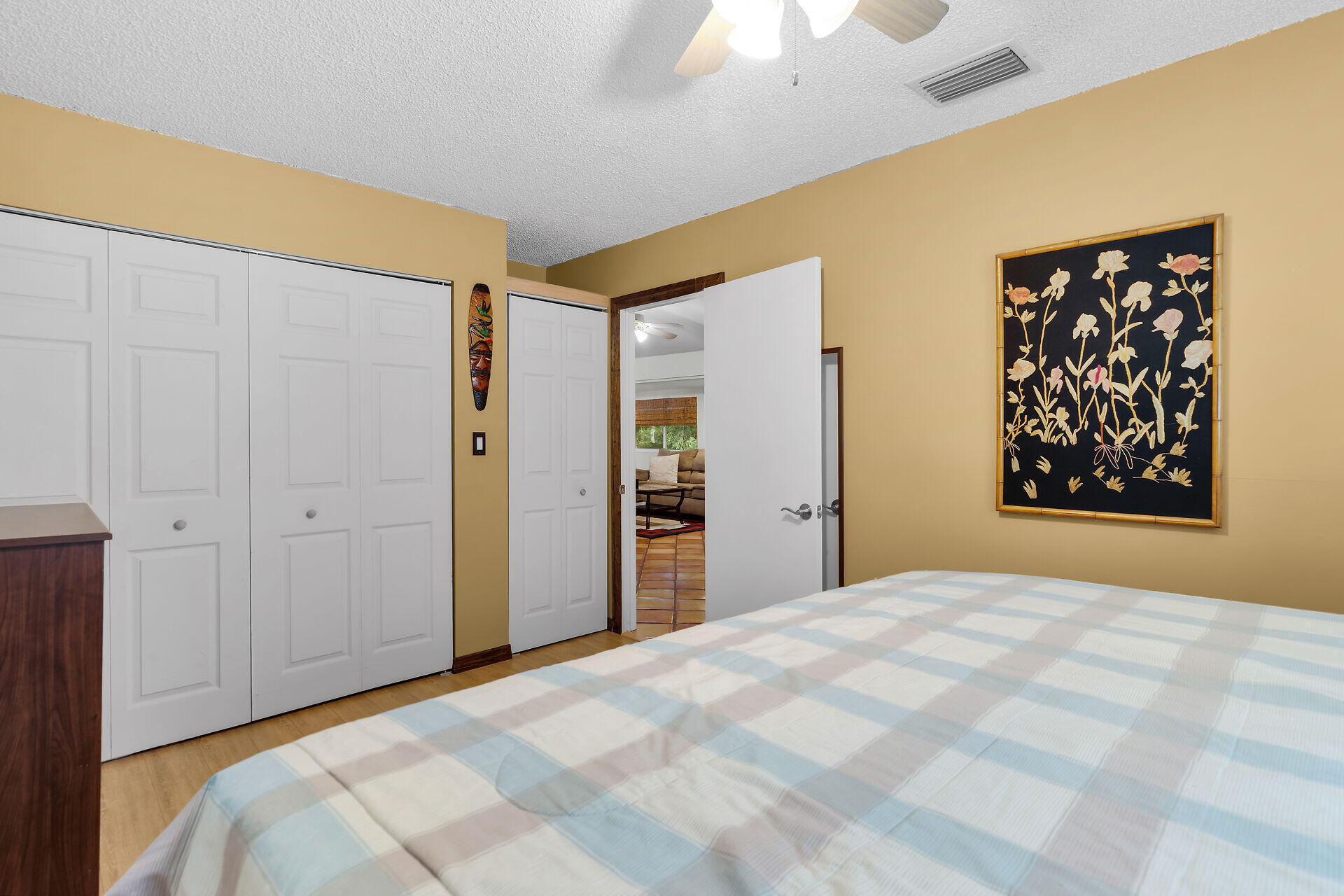 323 Bayview Avenue Key Largo, FL 33037 - Photo 27 of 46 a bedroom with a large bed and a chandelier
