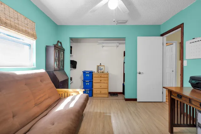 a bedroom with furniture and a wooden floor
