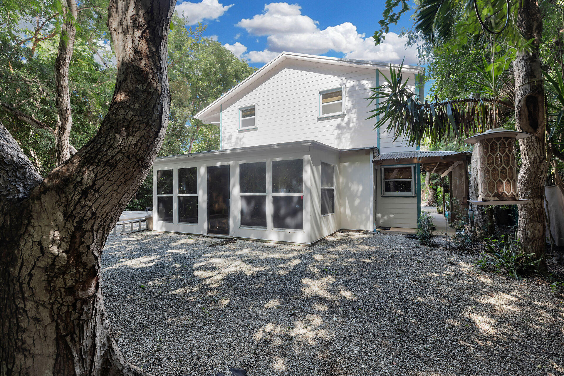 323 Bayview Avenue Key Largo, FL 33037 - Photo 7 of 46 a front view of a house with a yard and garage
