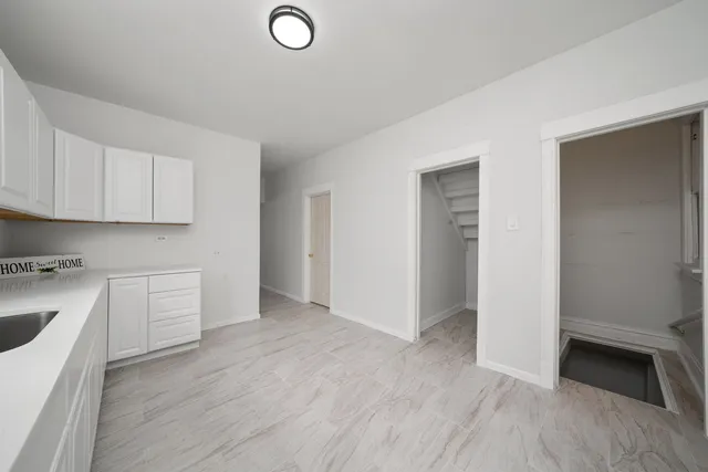 a view of a kitchen with wooden floor and electronic appliances